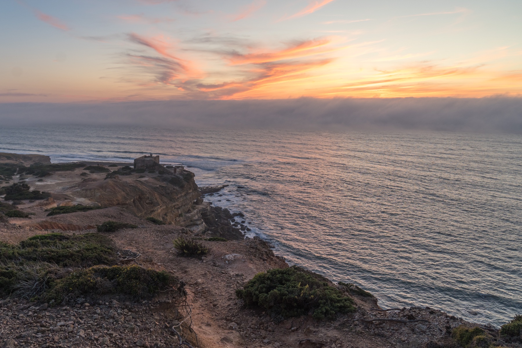 Sunset over cliffs and the Atlantic Ocean at Ericeira, Portugal.